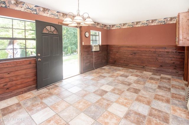 146 Lake Hills Dr, Oak Ridge, TN 37830 - unfurnished dining area with a chandelier, wood walls, and cooling unit