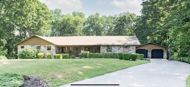 146 Lake Hills Dr, Oak Ridge, TN 37830 - ranch-style home with stone siding, an outdoor structure, a front lawn, and driveway