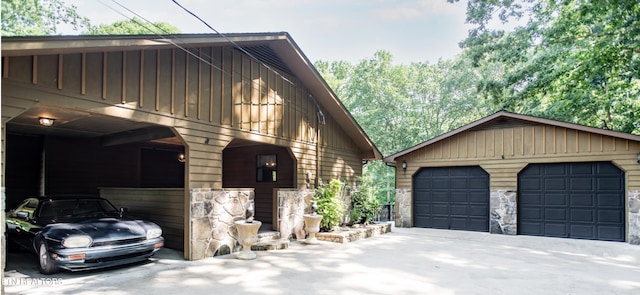 146 Lake Hills Dr, Oak Ridge, TN 37830 - view of side of property featuring stone siding, an outbuilding, a detached garage, and board and batten siding