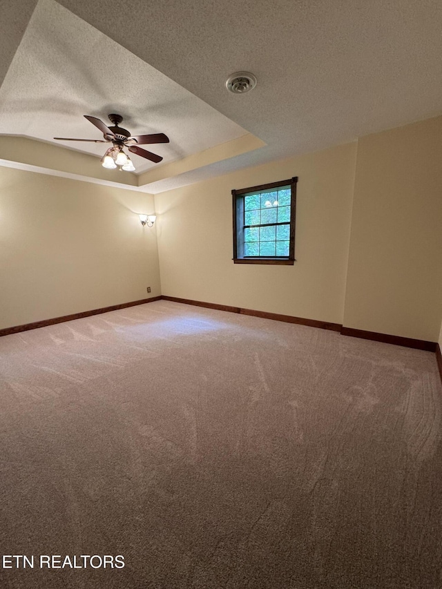 146 Lake Hills Dr, Oak Ridge, TN 37830 - unfurnished room with carpet floors, a textured ceiling, a ceiling fan, and a tray ceiling