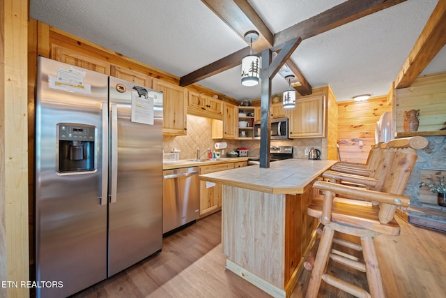1516 Zurich Rd, Gatlinburg, TN 37738 - kitchen with appliances with stainless steel finishes, tile countertops, light brown cabinetry, open shelves, and beamed ceiling