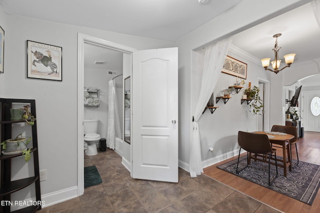 1132 Connecticut Ave, Knoxville, TN 37921 - entrance foyer with a chandelier, arched walkways, ornamental molding, and dark stone finish floors