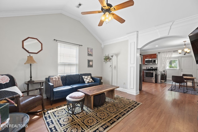 1132 Connecticut Ave, Knoxville, TN 37921 - living area featuring a ceiling fan, wood finished floors, vaulted ceiling, arched walkways, and a chandelier