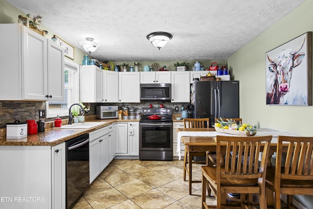 155 Kay Springs Cir, Jacksboro, TN 37757 - kitchen with black appliances, decorative backsplash, white cabinetry, and a textured ceiling