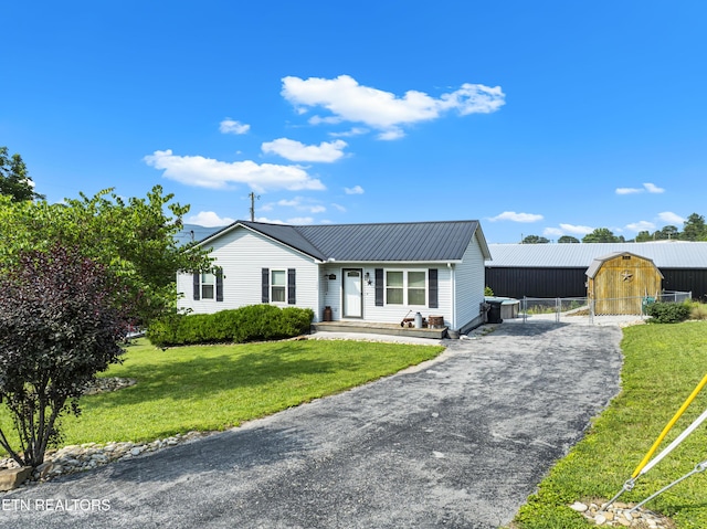 155 Kay Springs Cir, Jacksboro, TN 37757 - ranch-style home with a metal roof, an outdoor structure, and asphalt driveway