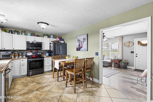 155 Kay Springs Cir, Jacksboro, TN 37757 - kitchen with appliances with stainless steel finishes, tasteful backsplash, white cabinetry, a textured ceiling, and ceiling fan