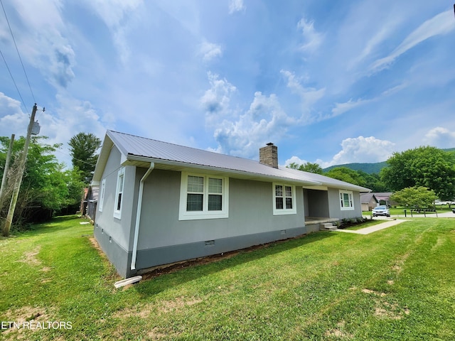 212 Ellison Rd, Lafollette, TN 37766 - rear view of property with crawl space, a metal roof, a lawn, and a chimney