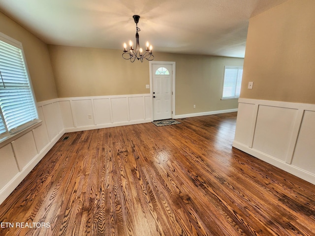 212 Ellison Rd, Lafollette, TN 37766 - empty room with a chandelier, wainscoting, wood finished floors, and a decorative wall