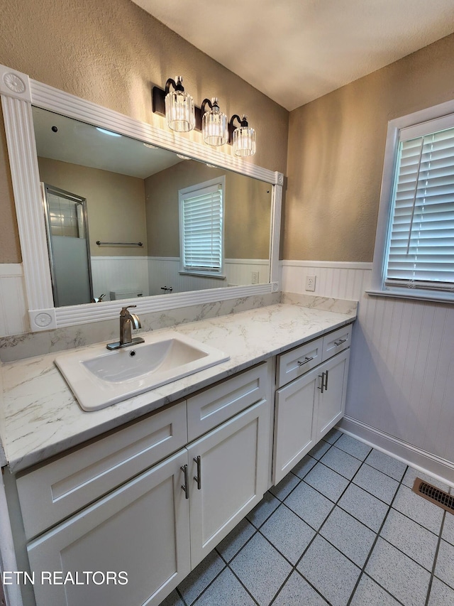212 Ellison Rd, Lafollette, TN 37766 - full bathroom featuring a wainscoted wall, vanity, and tile patterned floors