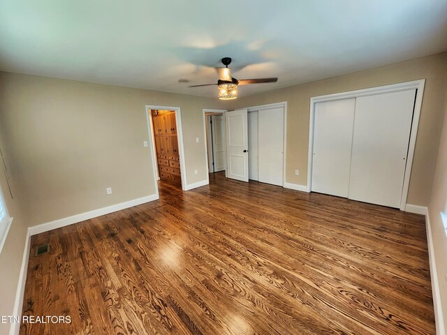 212 Ellison Rd, Lafollette, TN 37766 - unfurnished bedroom featuring multiple closets, wood finished floors, and ceiling fan