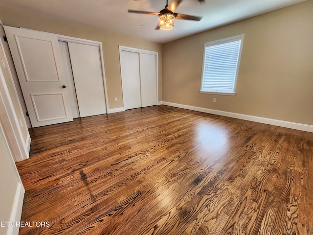 212 Ellison Rd, Lafollette, TN 37766 - unfurnished bedroom with two closets, wood finished floors, and a ceiling fan