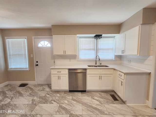 212 Ellison Rd, Lafollette, TN 37766 - kitchen with stainless steel dishwasher, white cabinets, and light countertops