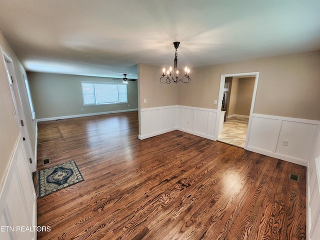 212 Ellison Rd, Lafollette, TN 37766 - unfurnished dining area featuring a chandelier, wood finished floors, a wainscoted wall, a decorative wall, and ceiling fan