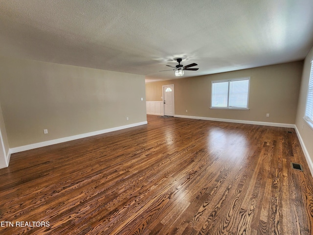 212 Ellison Rd, Lafollette, TN 37766 - unfurnished living room with dark wood-type flooring, ceiling fan, and a textured ceiling