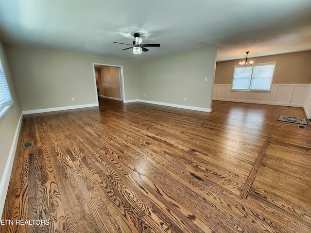212 Ellison Rd, Lafollette, TN 37766 - unfurnished room featuring a chandelier, wood finished floors, ceiling fan, and wainscoting