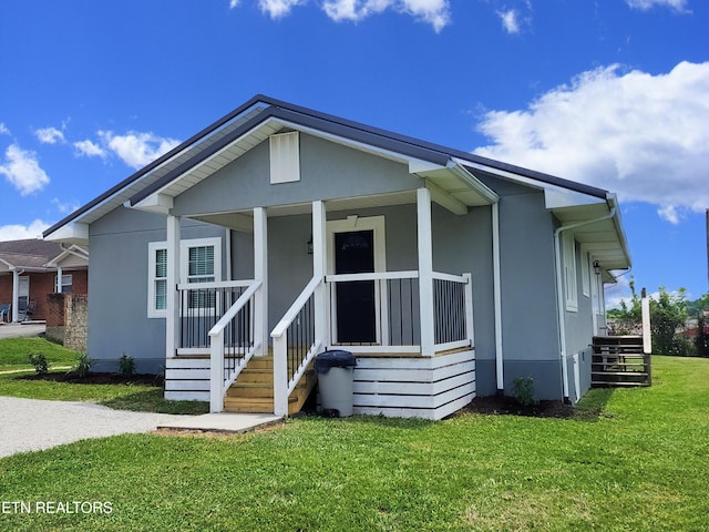 212 Ellison Rd, Lafollette, TN 37766 - view of front of home featuring a front yard, stucco siding, stairway, and covered porch