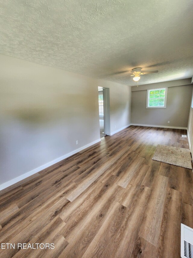 918 5th St, Jellico, TN 37762 - spare room featuring a textured ceiling, a ceiling fan, and wood finished floors