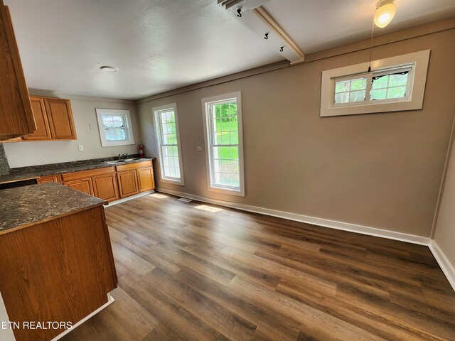 918 5th St, Jellico, TN 37762 - kitchen with plenty of natural light, brown cabinetry, and dark wood finished floors