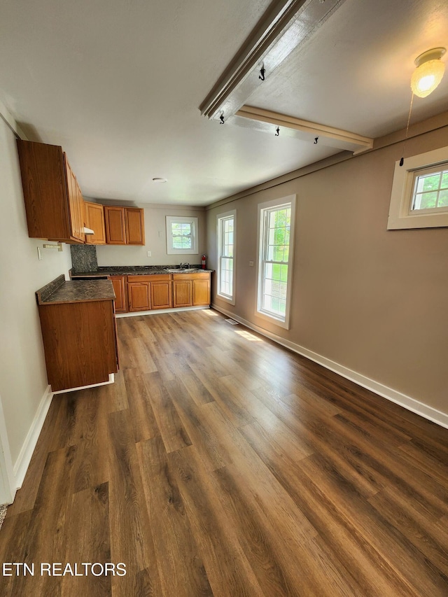 918 5th St, Jellico, TN 37762 - kitchen featuring brown cabinetry, dark countertops, and dark wood-style floors