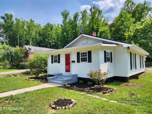 918 5th St, Jellico, TN 37762 - view of front facade with a front yard and a chimney