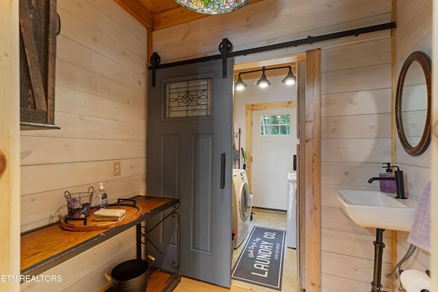 187 Persimmon Ln, Pioneer, TN 37847 - laundry area featuring a barn door, wood walls, and washer / clothes dryer