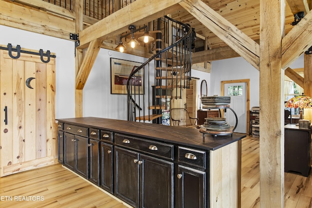 187 Persimmon Ln, Pioneer, TN 37847 - bar area featuring light wood-style flooring, beamed ceiling, and stairs
