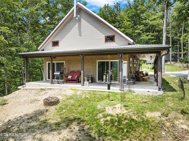 187 Persimmon Ln, Pioneer, TN 37847 - back of house featuring an outdoor fire pit, a metal roof, a yard, and a patio area