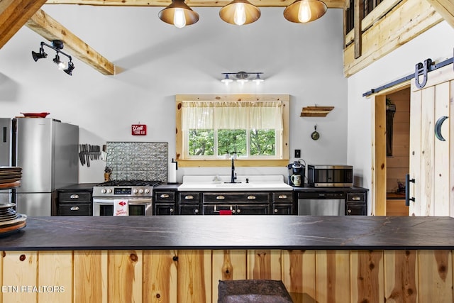 187 Persimmon Ln, Pioneer, TN 37847 - kitchen featuring stainless steel appliances, dark countertops, a barn door, and dark cabinets
