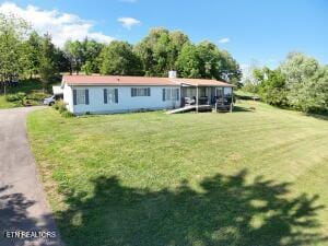 2517 Shields Ferry Rd, Morristown, TN 37814 - back of property featuring a lawn and asphalt driveway