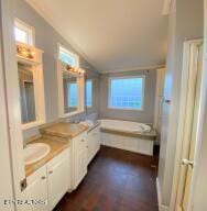 2517 Shields Ferry Rd, Morristown, TN 37814 - bathroom with double vanity, a bath, and lofted ceiling