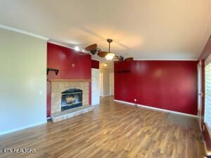 2517 Shields Ferry Rd, Morristown, TN 37814 - unfurnished living room with wood finished floors, a glass covered fireplace, and ornamental molding