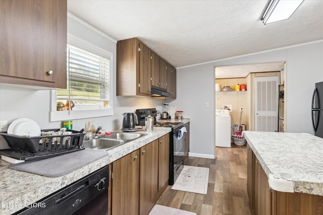 1309 Elm Village Ct, Dandridge, TN 37725 - kitchen with black appliances, washer / dryer, dark wood-style flooring, under cabinet range hood, and light countertops
