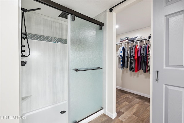 1309 Elm Village Ct, Dandridge, TN 37725 - bathroom featuring a stall shower, wood finished floors, and a spacious closet