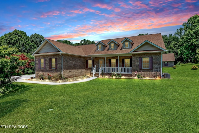 1721 N Parkridge Dr, Knoxville, TN 37924 - view of front of house featuring covered porch, brick siding, and a front lawn