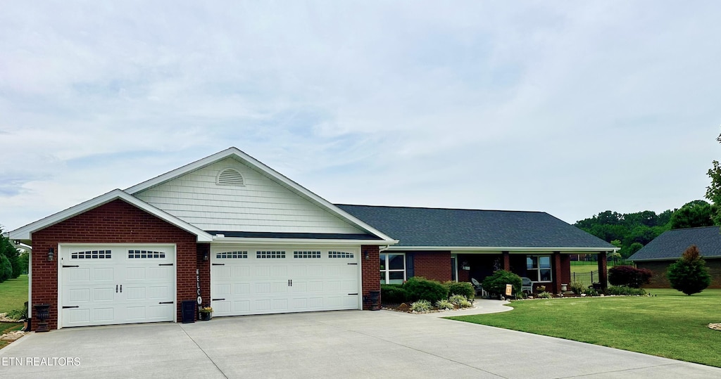 1045 Southwind Cir, Dandridge, TN 37725 - ranch-style house featuring a front lawn, brick siding, driveway, and a garage