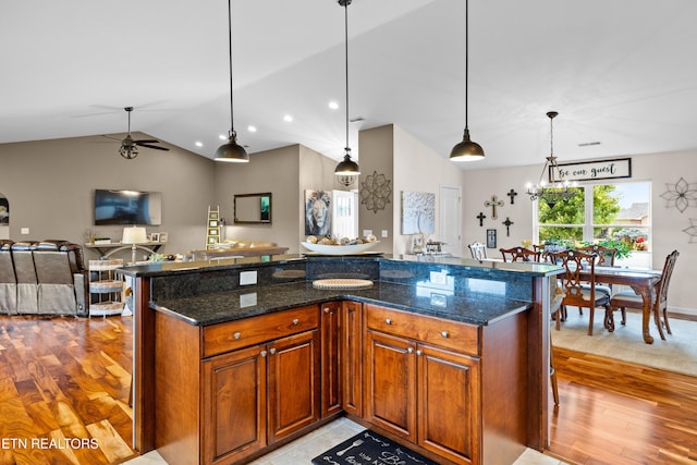 1045 Southwind Cir, Dandridge, TN 37725 - kitchen with lofted ceiling, ceiling fan, light wood-style flooring, open floor plan, and hanging light fixtures