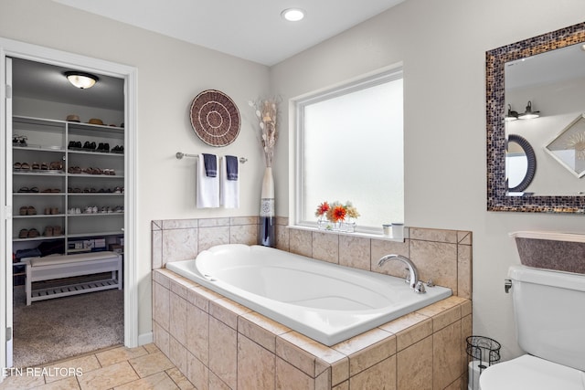 1045 Southwind Cir, Dandridge, TN 37725 - bathroom with a garden tub, a spacious closet, and tile patterned floors