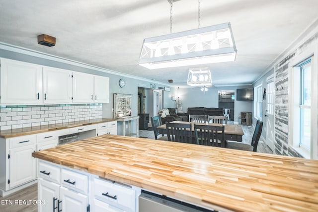 1820 Locust Grove Rd, New Tazewell, TN 37825 - kitchen featuring butcher block countertops, white cabinets, crown molding, backsplash, and open floor plan