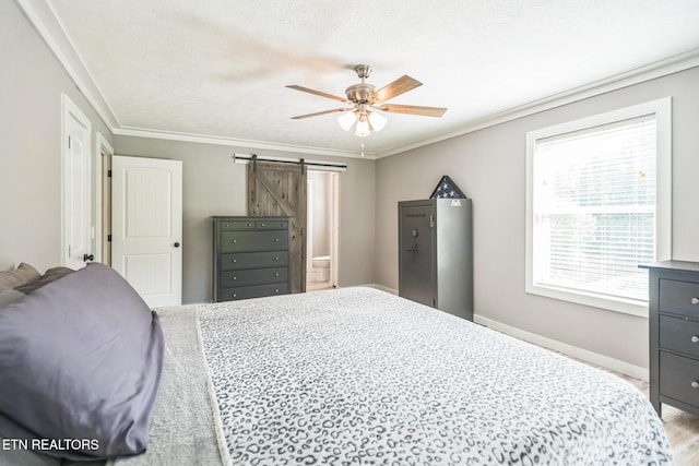 1820 Locust Grove Rd, New Tazewell, TN 37825 - bedroom with a barn door, wood finished floors, ornamental molding, and ceiling fan
