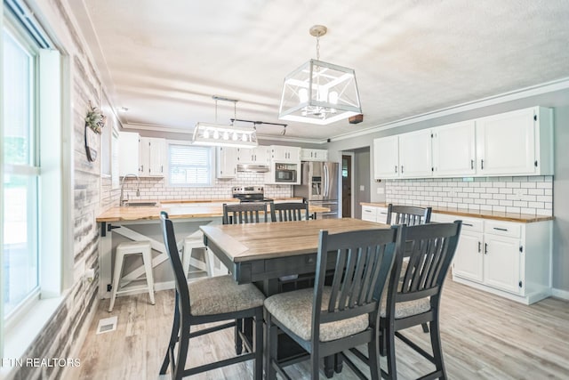 1820 Locust Grove Rd, New Tazewell, TN 37825 - dining space with crown molding, light wood-type flooring, and a chandelier