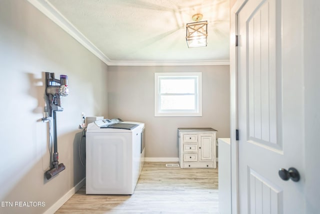 1820 Locust Grove Rd, New Tazewell, TN 37825 - laundry room with washing machine and clothes dryer, ornamental molding, light wood finished floors, and a textured ceiling