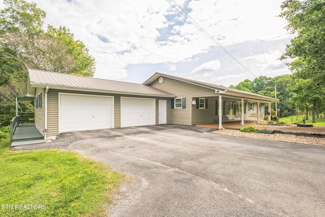 1820 Locust Grove Rd, New Tazewell, TN 37825 - ranch-style home with an attached garage, driveway, a metal roof, and a porch