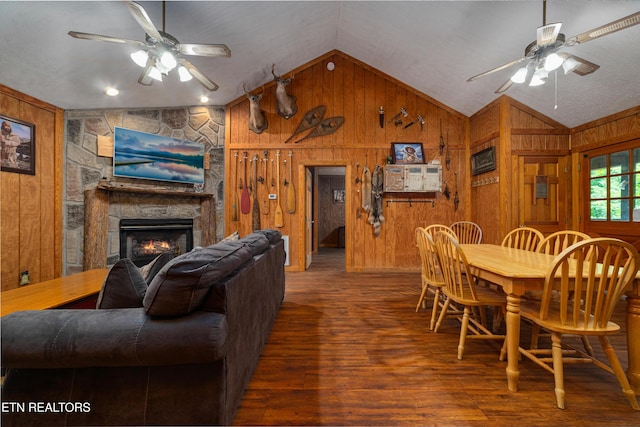 719 Kings Hills Blvd, Pigeon Forge, TN 37863 - dining room with ceiling fan, vaulted ceiling, wooden walls, wood finished floors, and a stone fireplace