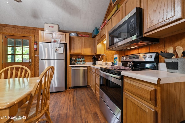 719 Kings Hills Blvd, Pigeon Forge, TN 37863 - kitchen with appliances with stainless steel finishes, light countertops, dark wood-style floors, and brown cabinets
