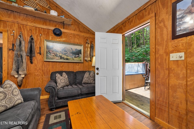 719 Kings Hills Blvd, Pigeon Forge, TN 37863 - living area with wood walls, vaulted ceiling, and wood finished floors