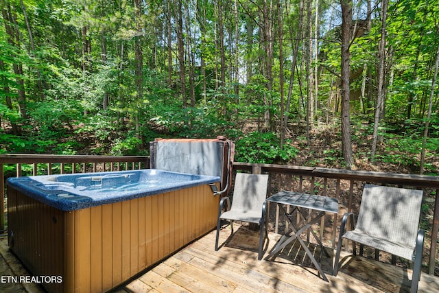 719 Kings Hills Blvd, Pigeon Forge, TN 37863 - wooden deck featuring a hot tub and a wooded view