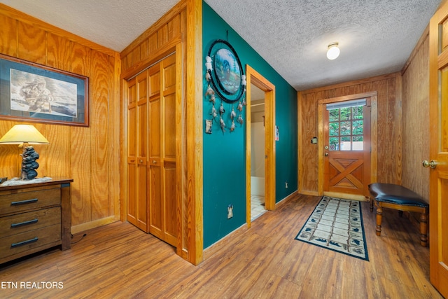 719 Kings Hills Blvd, Pigeon Forge, TN 37863 - entryway featuring wood walls, wood finished floors, and a textured ceiling
