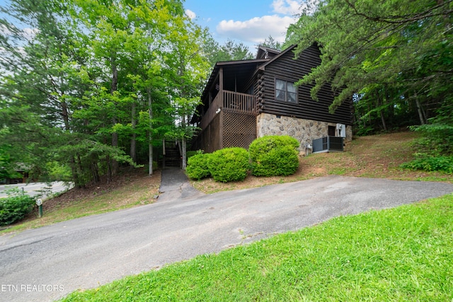719 Kings Hills Blvd, Pigeon Forge, TN 37863 - view of home's exterior with stone siding, log exterior, and stairway