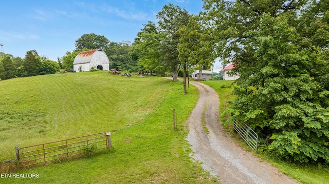 5750 E Lee Hwy, Loudon, TN 37774 - view of yard with a barn, dirt driveway, an outdoor structure, and a rural view