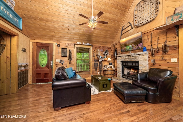 2389 Misty Ln, Sevierville, TN 37876 - living room with lofted ceiling, wooden ceiling, wood finished floors, a stone fireplace, and ceiling fan